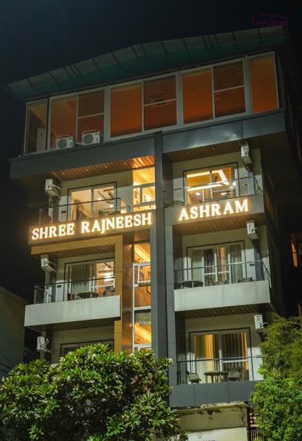 Shree Rajneesh Ashram building illuminated at night